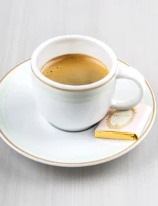 A small cup of dark, rich espresso with a layer of crema on top.