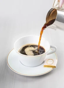 A cup of classic black coffee in a delicate Ladurée cup.