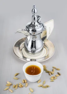 A traditional dallah pot and a small cup of light, spiced Saudi coffee.
