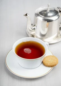 A cup of dark, fragrant Earl Grey tea with a slice of lemon.