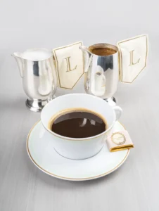 A cup of coffee with a splash of milk, creating a light brown hue.