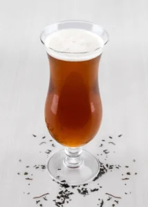 A glass of iced tea, garnished with lemon or mint.