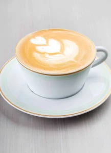 A cup of smooth coffee with a thin layer of microfoam on top.