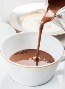 A rich hot chocolate topped with a generous swirl of Chantilly cream.