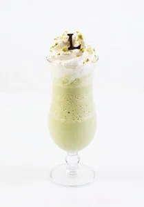 Pistachio Café Frappe blended with espresso, milk and Sicilian pistachio, topped with whipped cream and crushed pistachio